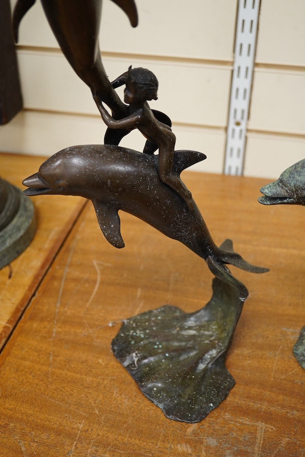 A pair of bronze leaping dolphin and amorini sculptures, unsigned, 54cm high. Condition - fair